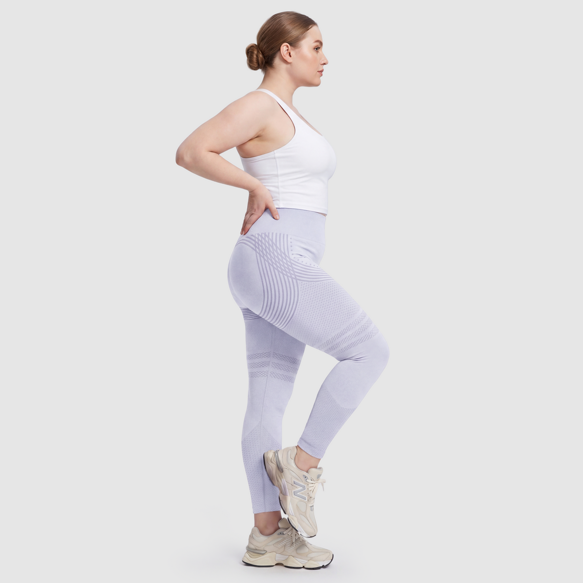 Mujer con leggings anticelulitis Sculpt 3D™ en azul claro, vista lateral, con las líneas de escultura 3D