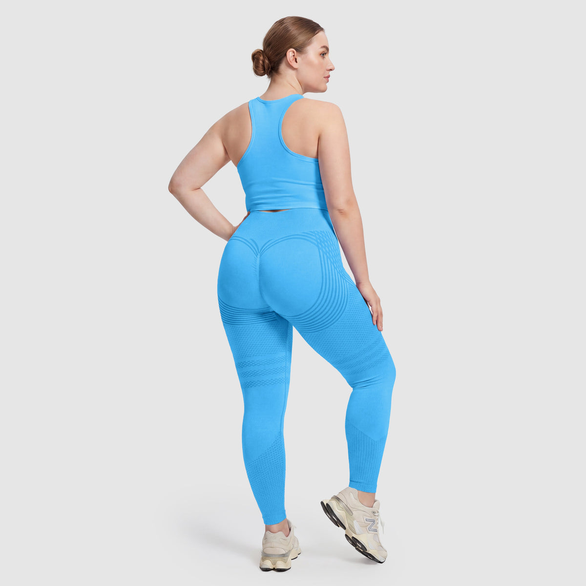Mujer con leggings anticelulitis Sculpt 3D™ en turquesa, vista de espalda, glúteos levantados y contorneados